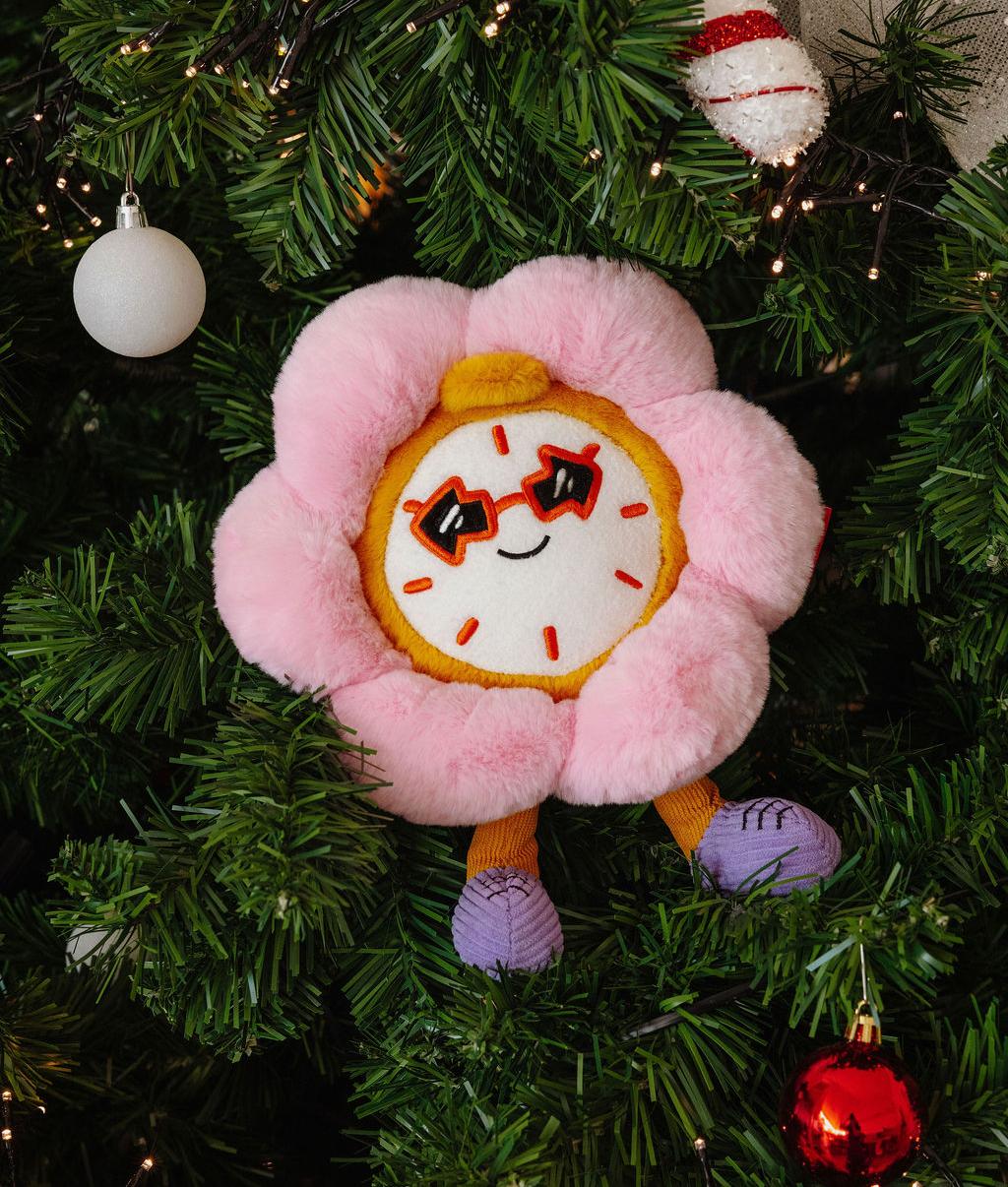 Peluche per bambini a forma di fiore rosa, viso sorridente e piedi viola Hello Hossy