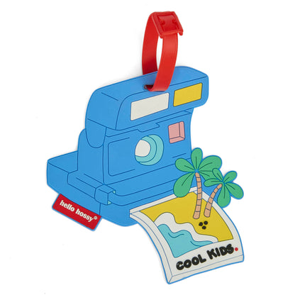 Etichetta per valigia per bambini blu a forma di fotocamera, manico rosso, foto da spiaggia Hello Hossy