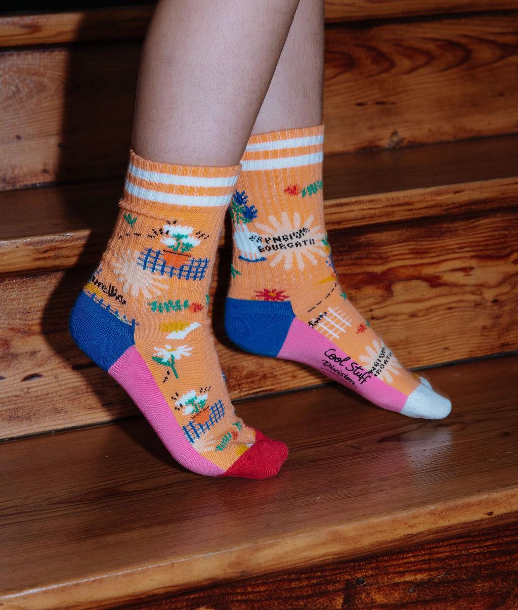Paio di calzini con motivi a fiori, talloni e punte colorati, indossati da un bambino – foto lifestyle – Hello Hossy