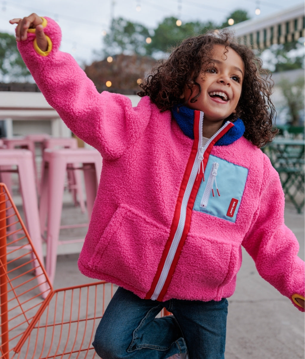 Giacca in pile da bambino fuchsia con tasca blu con zip Hello Hossy